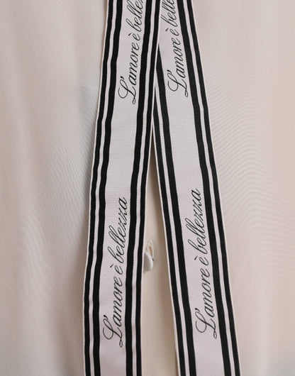 بلوزة دولتشي آند غابانا بيضاء بأكمام طويلة وأزرار